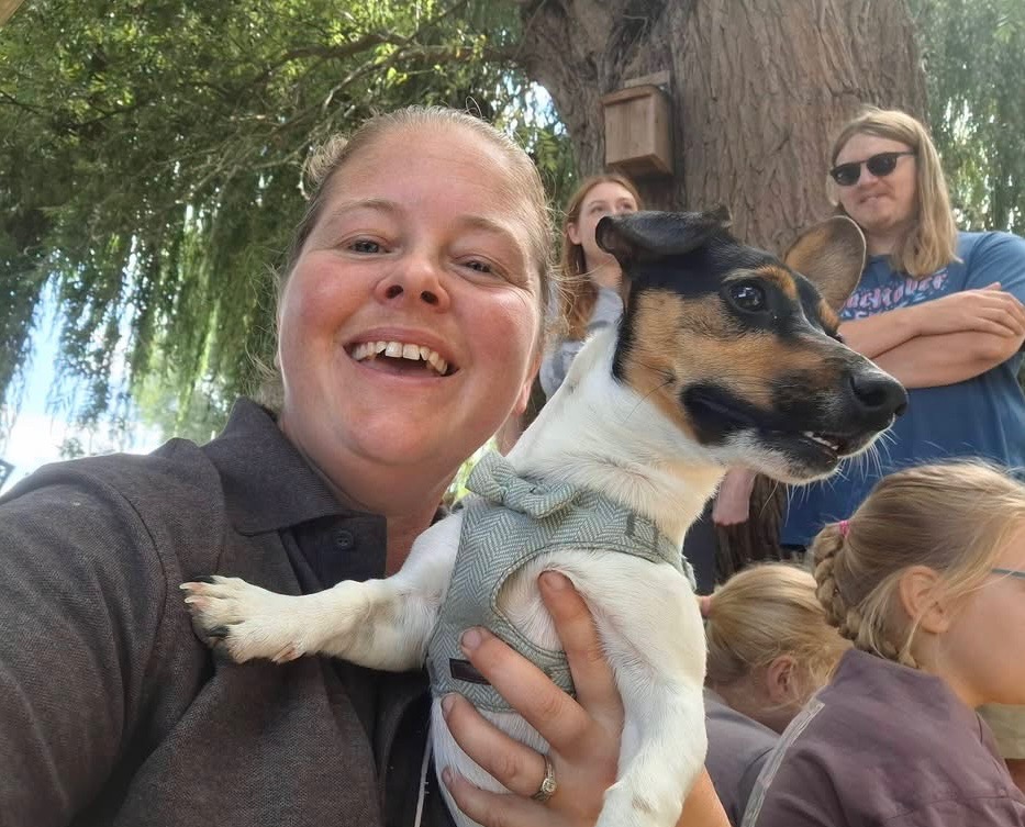 An owner smiling with their dog at The Deben Dog Hub